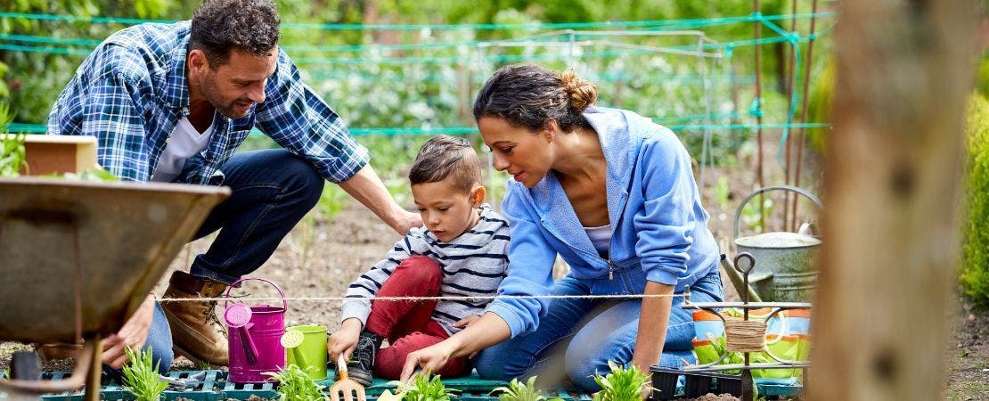 family planting in garden